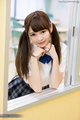 Leaning against sliding window hair in pigtails wearing uniform