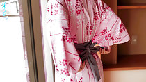 Hands behind her back loosening yukata