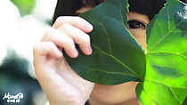 Playing with broad green leaves