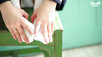Hands reaching down to her feet white socks