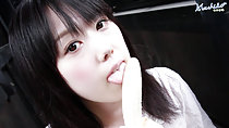 Machiko licking length of peeled banana