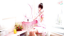 Turning phone off in pink cheongsam at dressing table