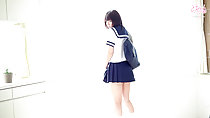 Standing against window looking over her shoulder wearing sailor suit uniform bag over her shoulder