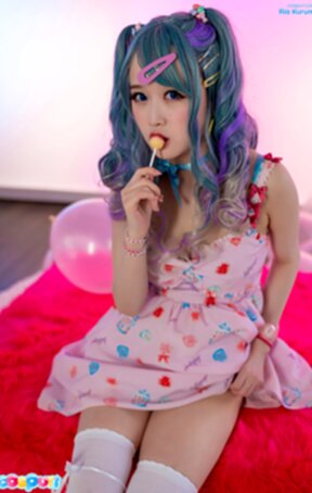 Ria Kurumi sucks lollipop while stripping dress and showing her shaved pussy