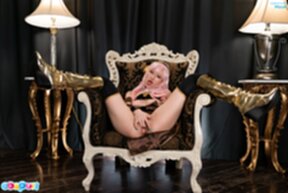 Mizuki spreads her legs wide on chair and fingers her pussy