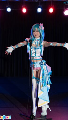 Ria Kurumi standing at microphone lowering her panties