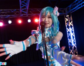 Ria Kurumi standing at microphone lowering her panties