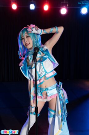 Ria Kurumi standing at microphone lowering her panties