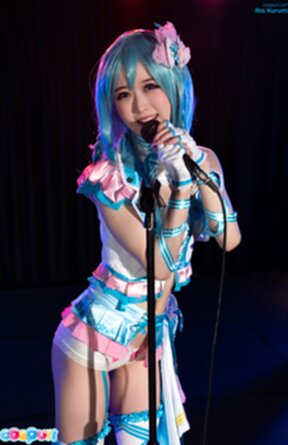 Ria Kurumi standing at microphone lowering her panties
