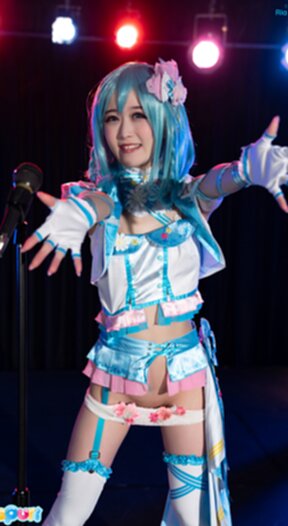 Ria Kurumi standing at microphone lowering her panties