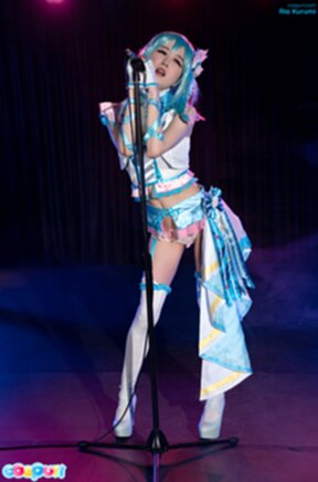 Ria Kurumi singing at microphone lowering panties