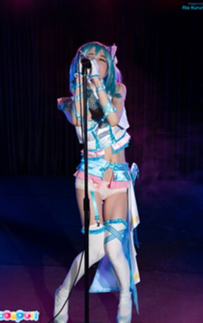 Ria Kurumi singing at microphone lowering panties