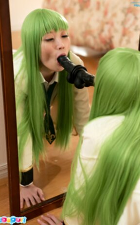 Mizuki on all fours in front of mirror sucking black dildo