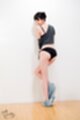 Standing against wall wearing black panties jeans pulled down