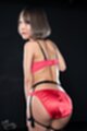 Wearing scarlet bra and panties short hair looking over her shoulder