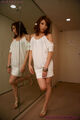 Standing beside mirror wearing white dress
