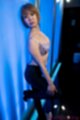 Leaning against wall wearing bra short hair