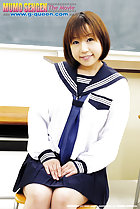 Sitting in kogal uniform in class hands on her lap