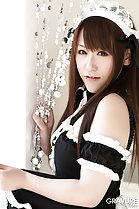 Tsubasa Sakurai in French maid uniform looking past her bare shoulder
