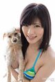 Holding dog wearing bikini top