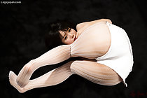 Sakura Sena curled up on floor wearing white shorts in pantyhose
