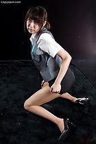 Office lady kneeling looking over her shoulder in short skirt wearing pantyhose and high heels