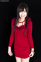 In red dress hands down by her side playing with hem of dress