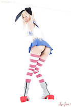 Looking over her shoulder wearing bunny ears in short skirt wearing stockings