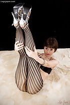 Legs raised in pantyhose wearing high heels