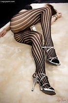 Knees drawn up in pantyhose high heels