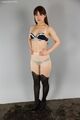 Hands on hips wearing bra and panties in pantyhose