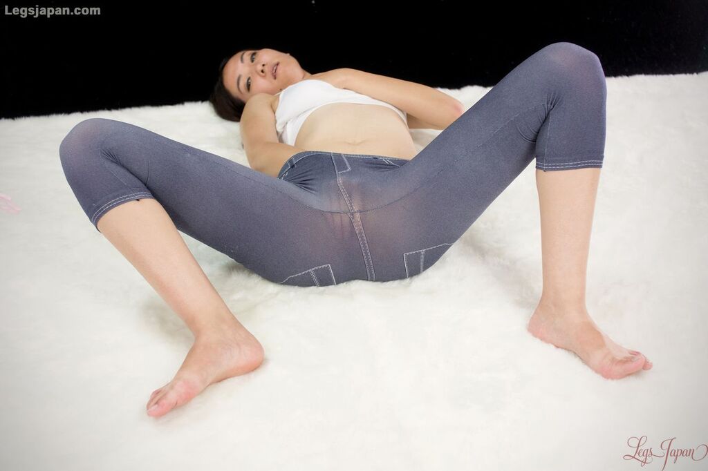 On her back legs spread masturbating in leggings