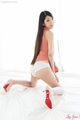 Kamimoto rio on her knees looking back long hair down her back dress raised exposing panties high heels