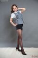 Hoshikawa uika with hand on hip in short skirt wearing pantyhose in high heels