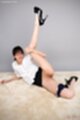Raising leg wearing high heels panties pulled down showing her shaved pussy