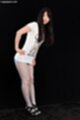 Leaning forward hands on hips wearing high heels
