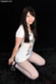 Wearing white top on her knees