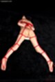 On her front nude tied up with rope