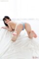 On all fours looking back wearing blue panties