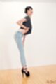 Leaning forward wearing jeans in high heels