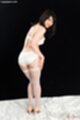 Looking back wearing white panties in stockings high heels