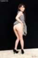Raising dress over her ass knees pressed together wearing black high heels
