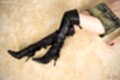 Lying on her back in short skirt black boots