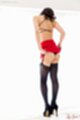 Raising short skirt wearing black panties in stockings high heels
