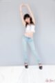 Arms raised wearing blue jeans in high heels