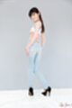 Looking over her shoulder long hair wearing jeans high heels