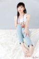 Top raised over her tits knees drawn up wearing jeans bare feet
