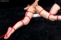 Maeshiro shizuka on her front nude hand on her ass tied up with rope
