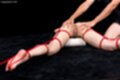 Lying on her front hands on her raised ass legs spread tied up